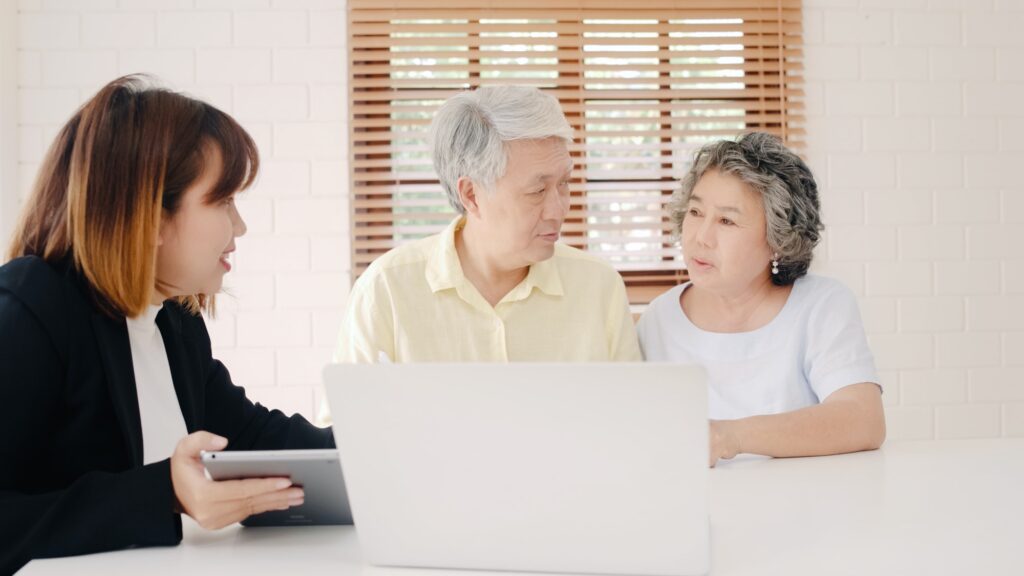 Asia smart female agent offers health insurance for elderly couples by document.