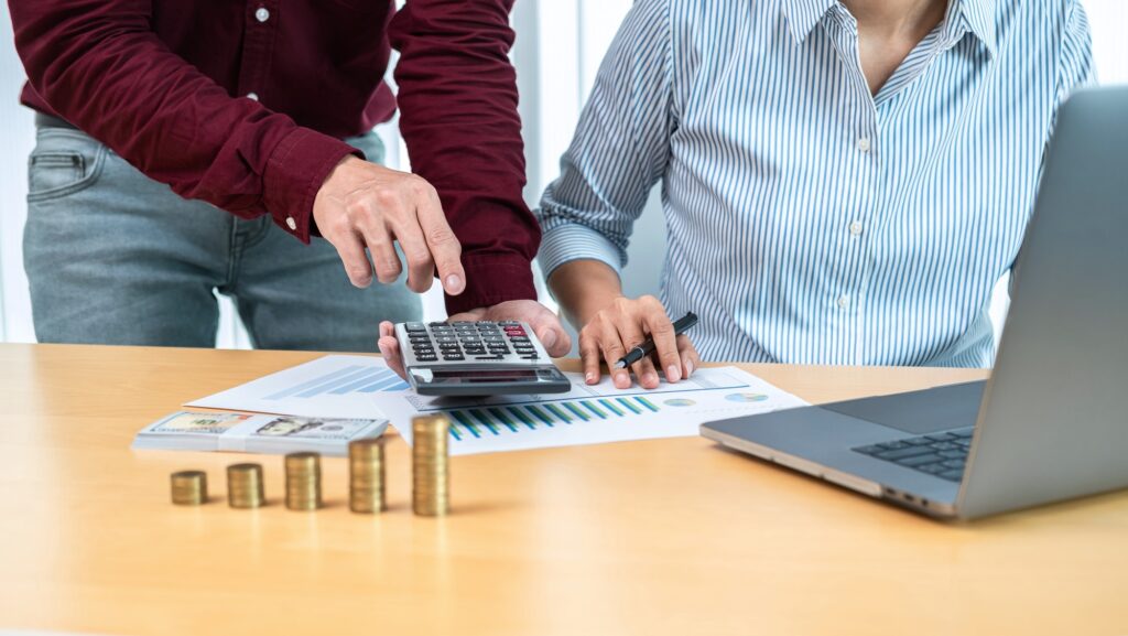 Business team working and discussion about house mortgage and property investment while stack coins