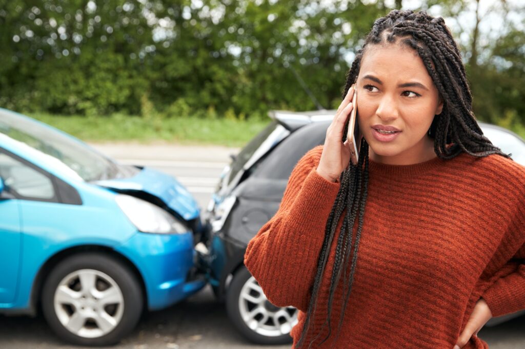 Female Motorist Involved In Car Accident Calling Insurance Company Or Recovery Service