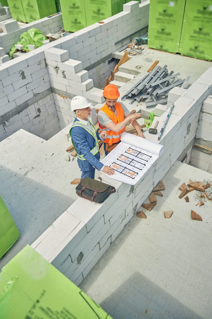 Pleased contractor listening to a civil engineer