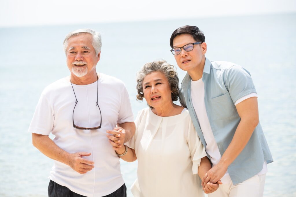 Portrait of happy Asian family travel and vacation at the beach.