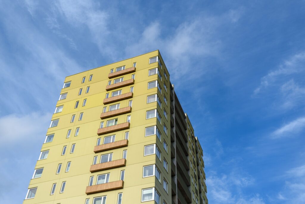 Tall residential building against blue sky